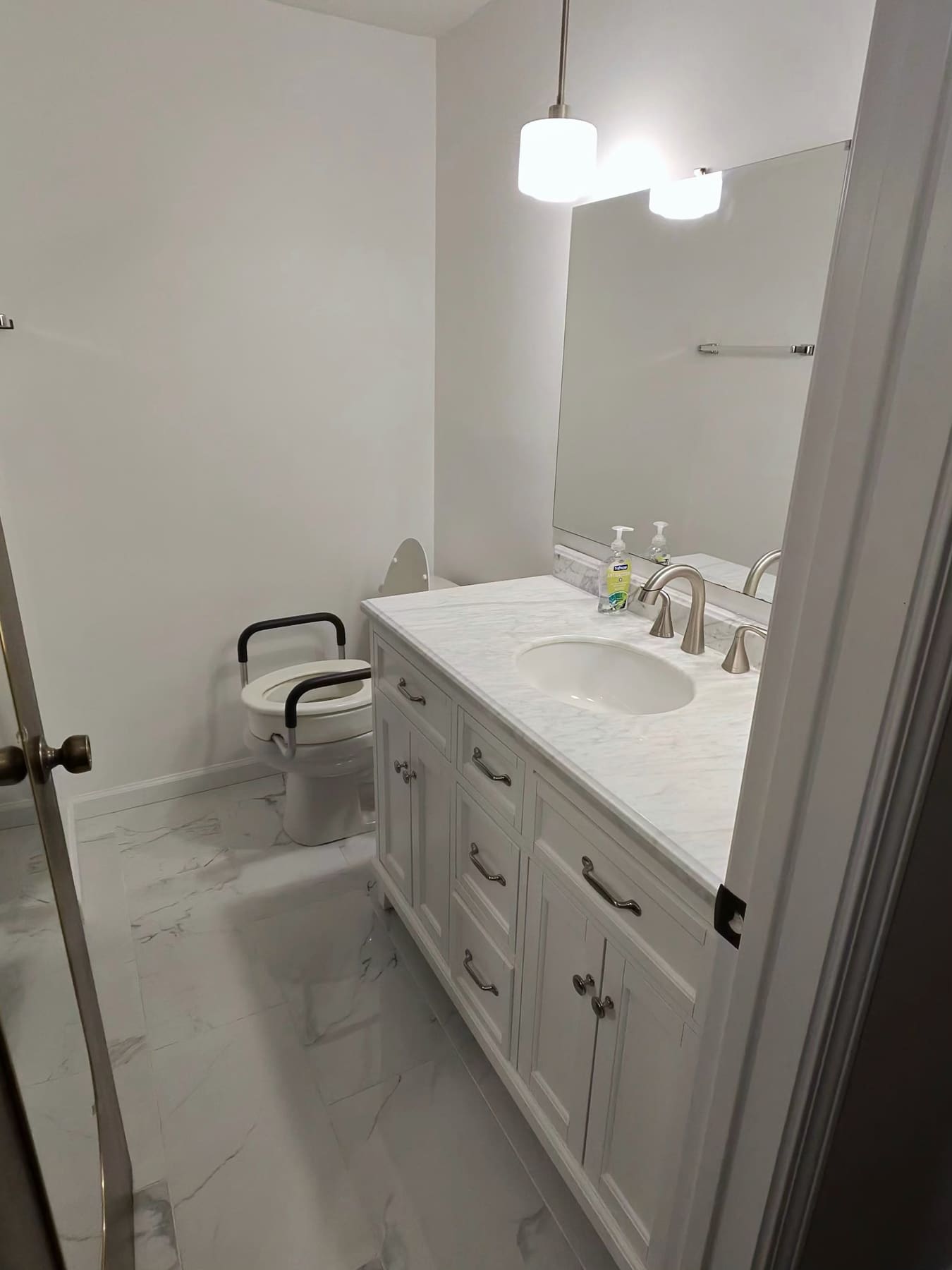 Bathroom with a white vanity, a shower seat, and a tile floor, cleaned