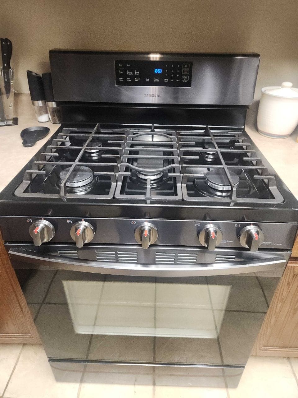 Stainless gas range with a five-burner cooktop, cleaned