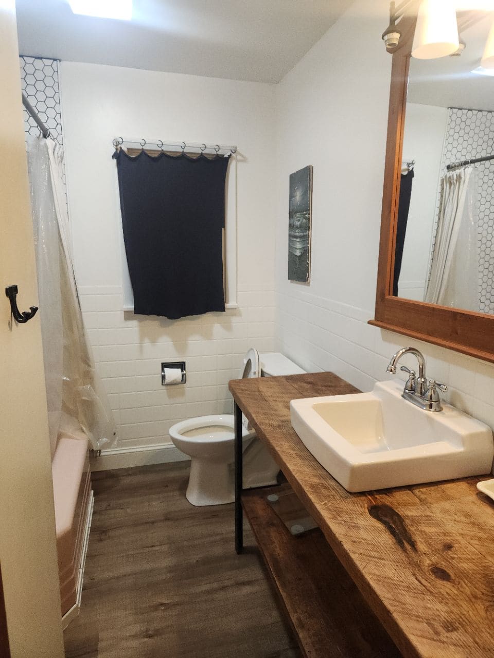 Bathroom with a live-edge wood vanity and a vessel-style sink, cleaned