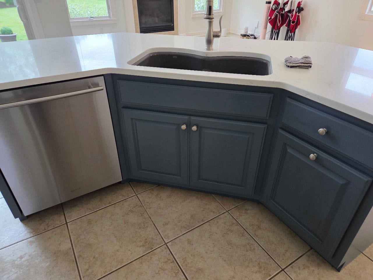 Kitchen with blue-gray cabinets, a white counter, and an undermount sink, cleaned